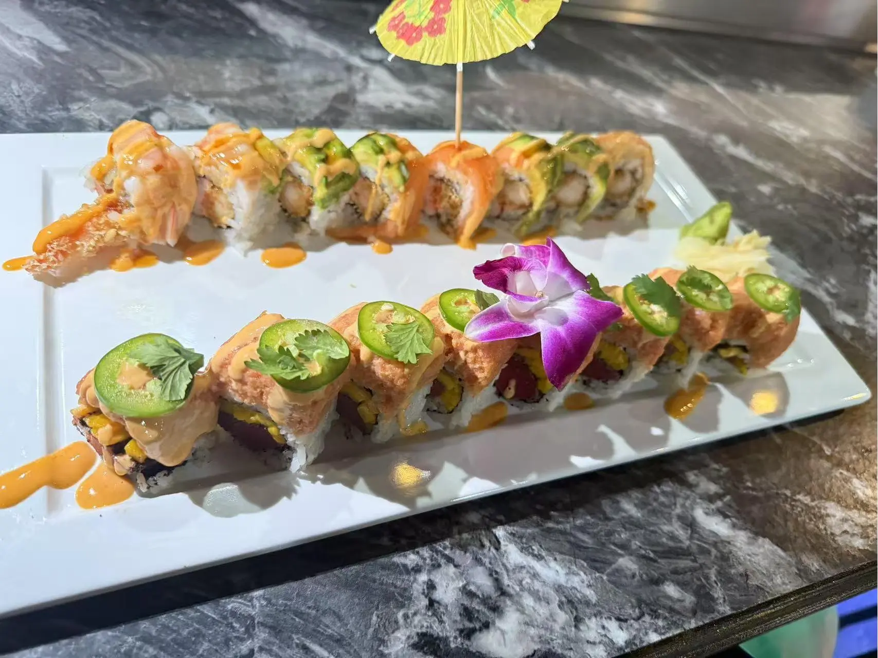 OK-Ramen&Sushi-Bar-Japanese-Restaurant-Creative-Sushi-Rolls-Oklahoma-City Creative Sushi Rolls - Artfully arranged sushi rolls with shrimp, avocado, and sauces at OK Ramen & Sushi Bar, a Japanese Restaurant in Oklahoma City