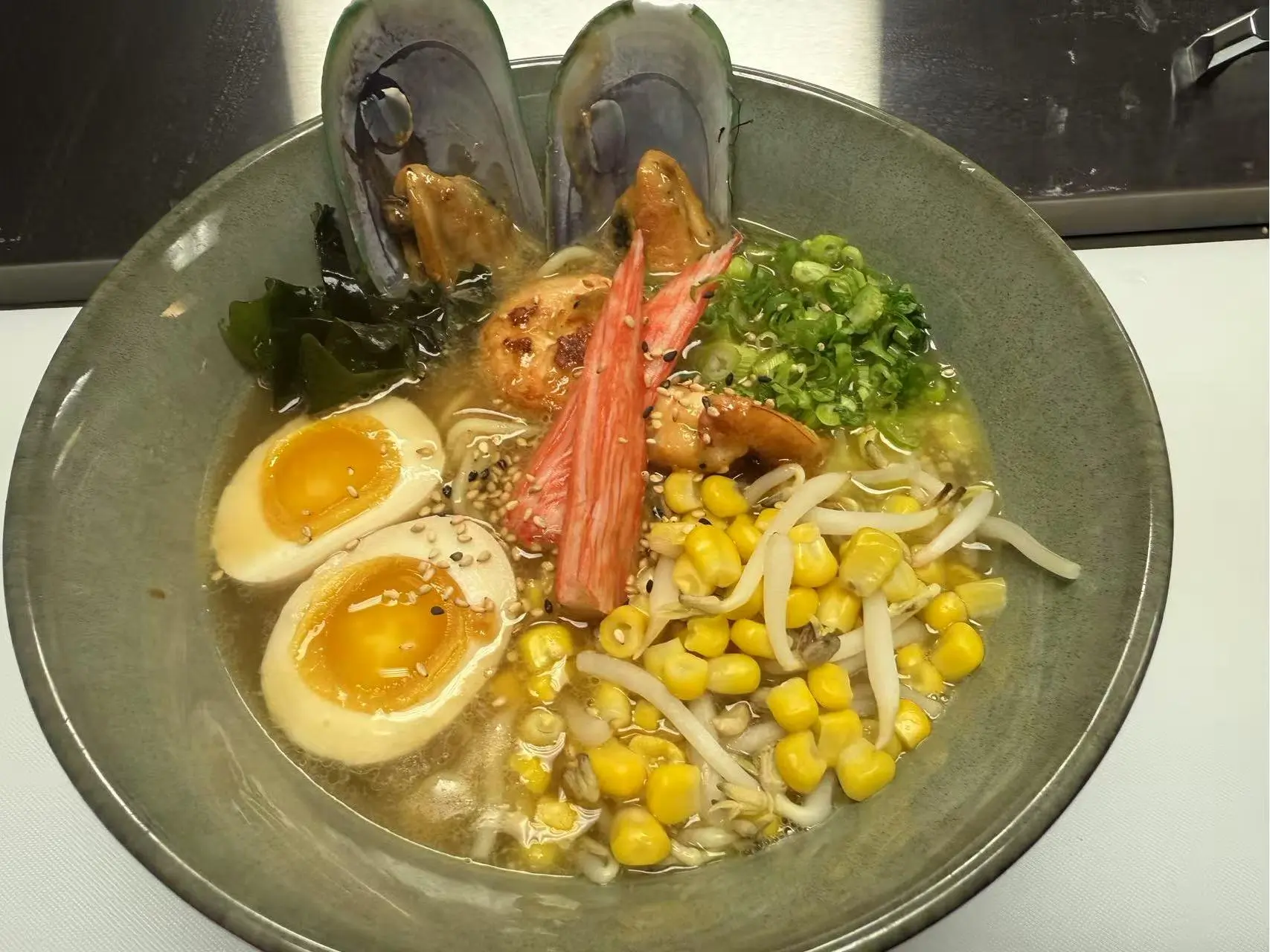 OK-Ramen&Sushi-Bar-Japanese-Restaurant-Seafood-Ramen-Oklahoma-City Seafood Ramen - Ramen in a rich broth with mussels, shrimp, eggs, and corn at OK Ramen & Sushi Bar, a Japanese Restaurant in Oklahoma City